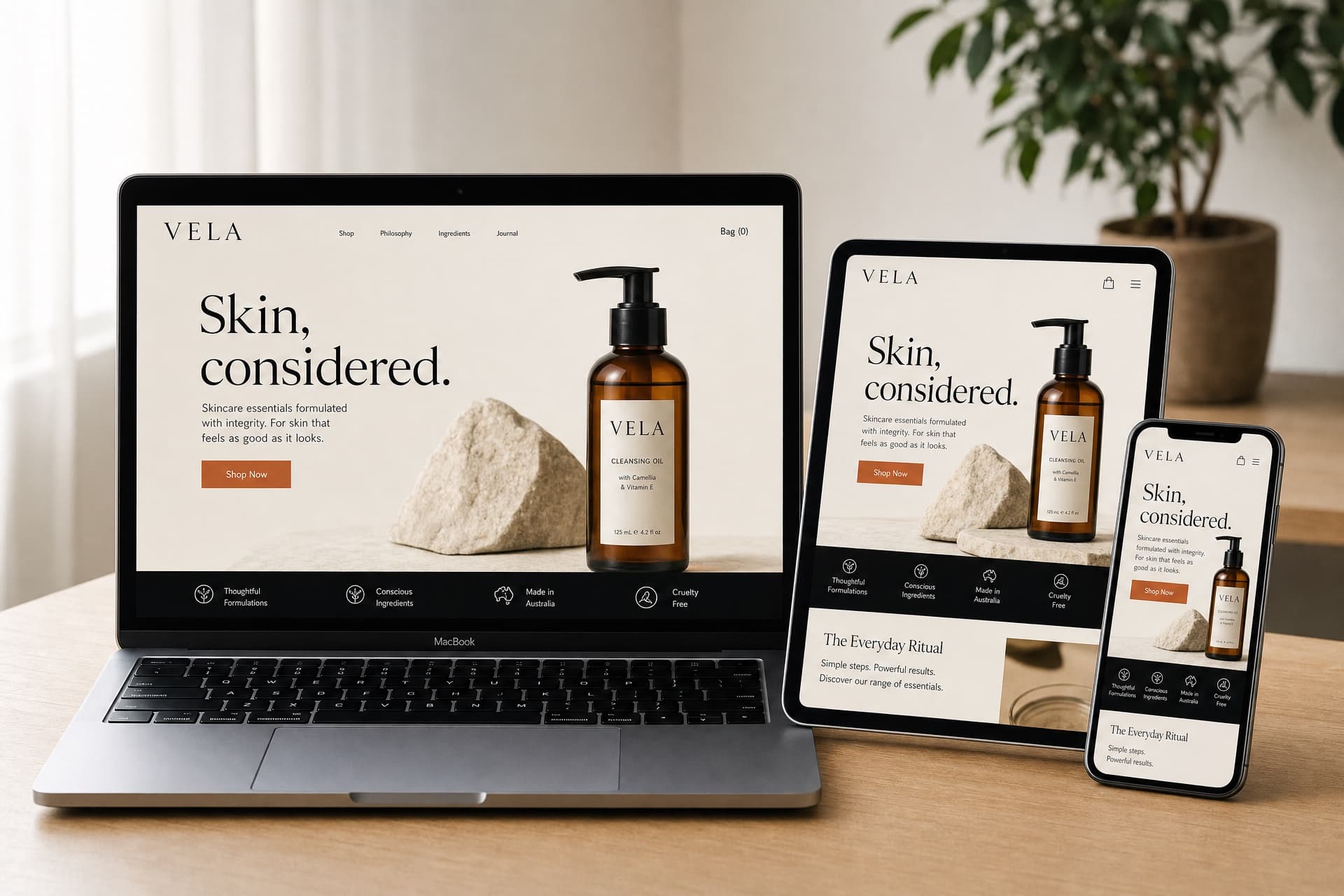 Conceptual responsive website mockup shown across laptop, tablet and phone