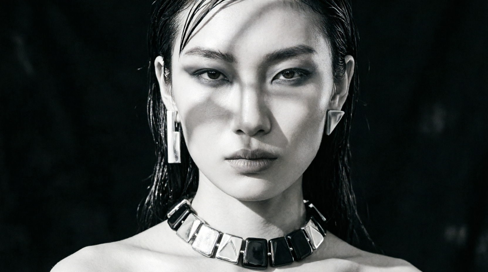 Accessories detail, sculptural silver necklace and earrings