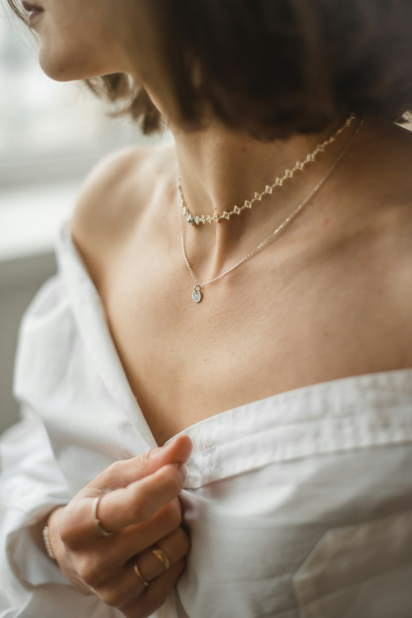 Model wearing layered gold necklaces from Tamannah Jewellers